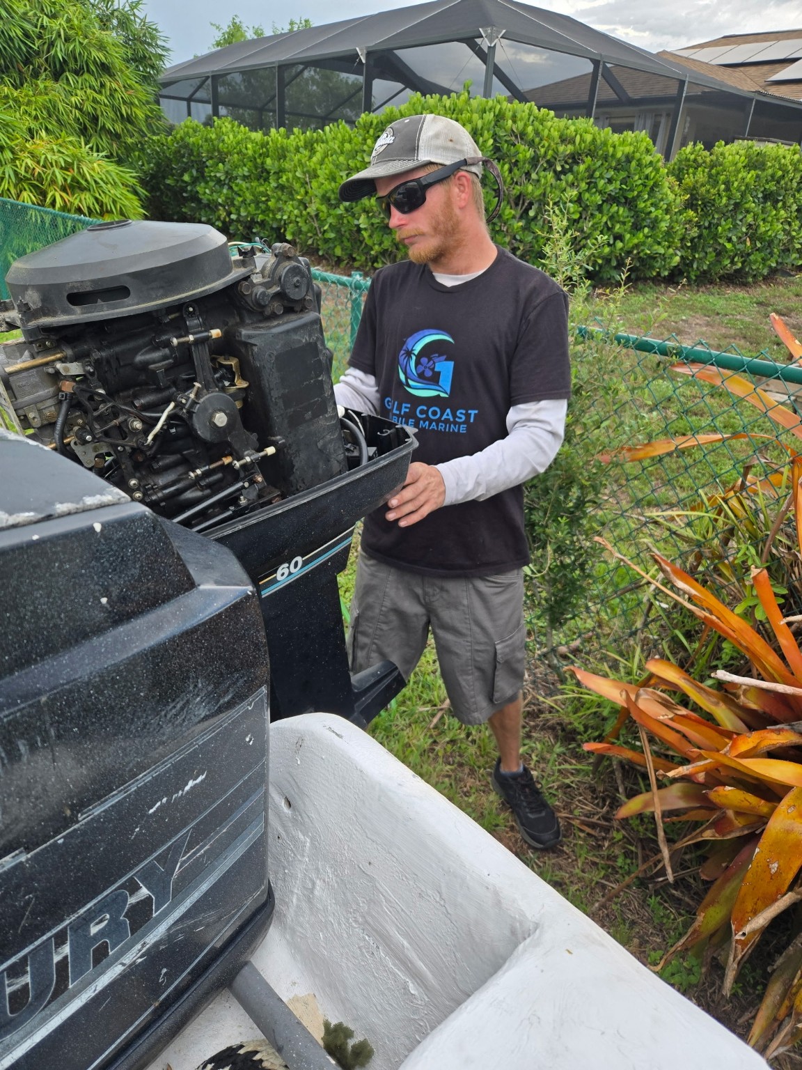 Technician servicing an outboard motor